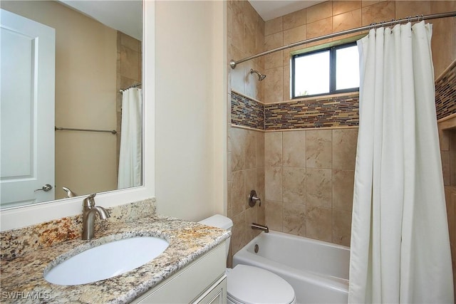 bathroom featuring vanity, shower / bath combo with shower curtain, and toilet