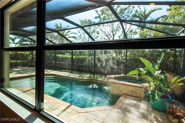 view of pool featuring a patio, a lanai, and a pool with connected hot tub