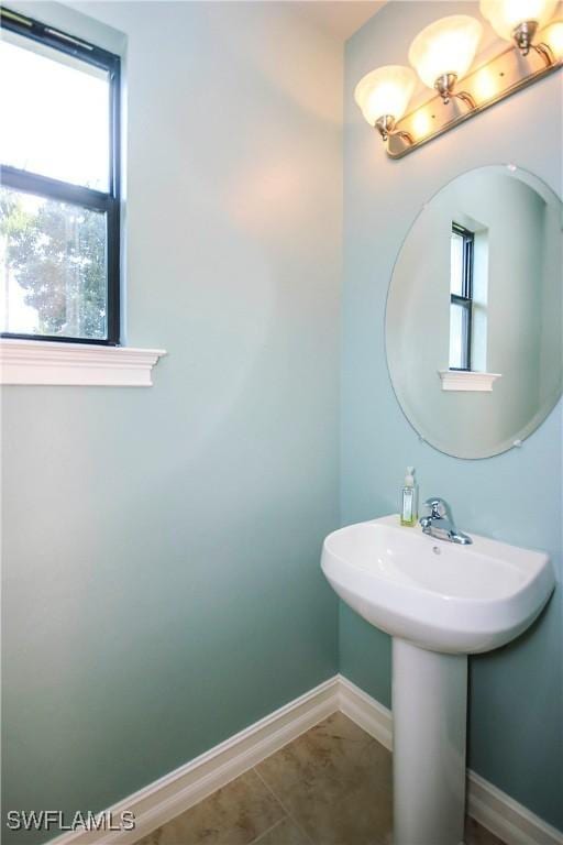 bathroom featuring baseboards and tile patterned floors