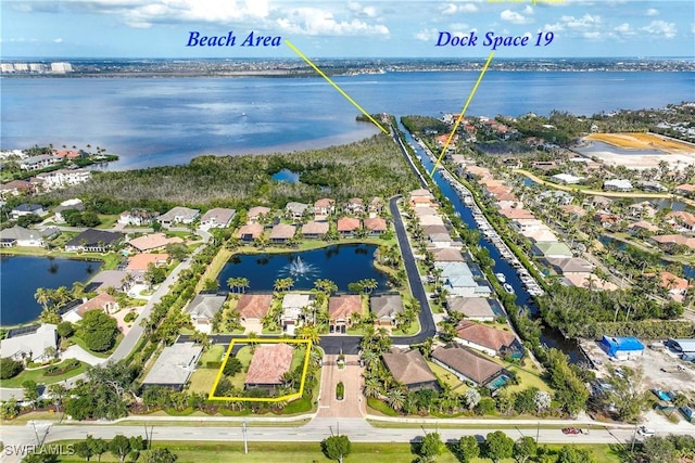 bird's eye view featuring a residential view and a water view