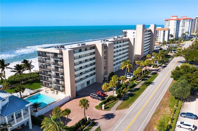 bird's eye view with a water view and a beach view