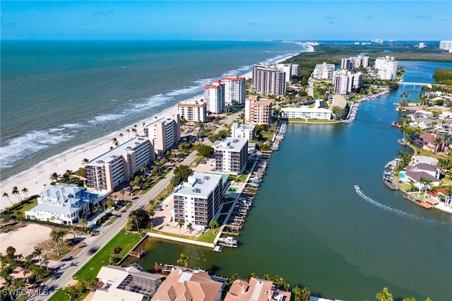 drone / aerial view featuring a beach view and a water view