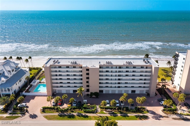 drone / aerial view featuring a water view and a beach view