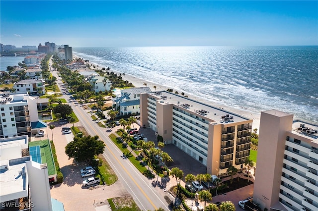 bird's eye view featuring a water view and a beach view