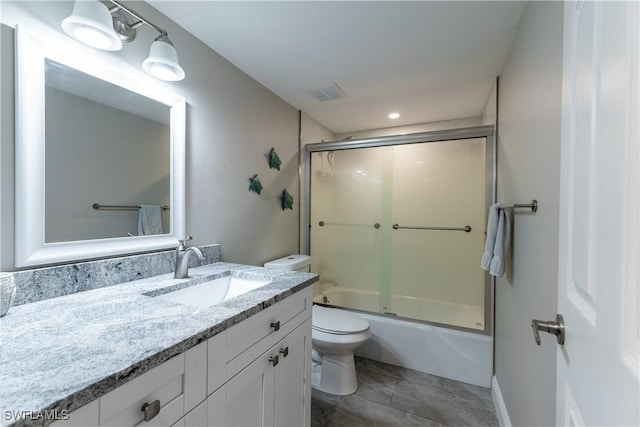 full bathroom featuring toilet, vanity, and shower / bath combination with glass door