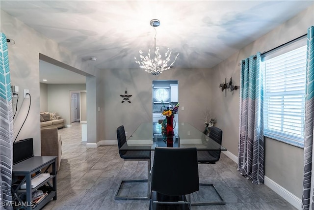 dining space featuring a notable chandelier