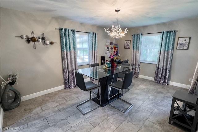 dining area featuring an inviting chandelier and a healthy amount of sunlight