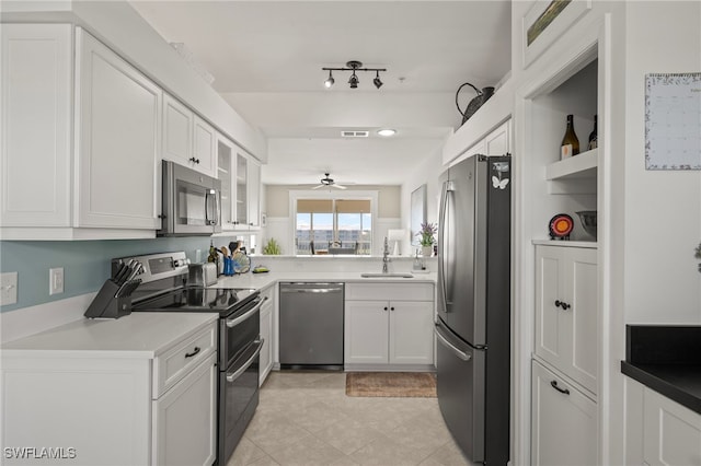 kitchen with white cabinetry, ceiling fan, appliances with stainless steel finishes, and sink