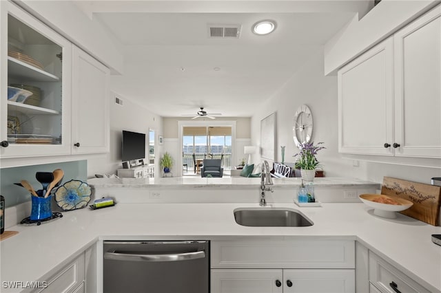 kitchen with white cabinetry, stainless steel dishwasher, sink, and ceiling fan