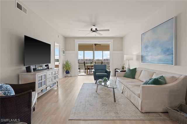 living room featuring ceiling fan and light hardwood / wood-style floors