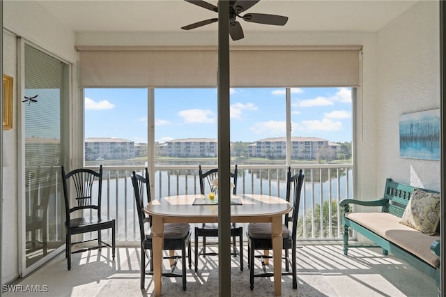 sunroom / solarium with a water view