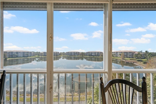 unfurnished sunroom featuring a water view