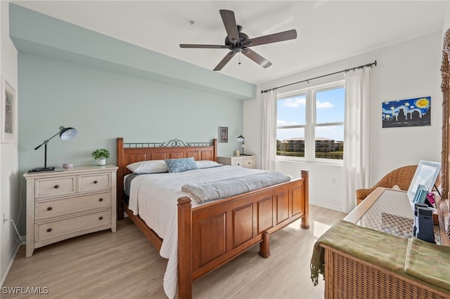 bedroom with ceiling fan and light hardwood / wood-style flooring