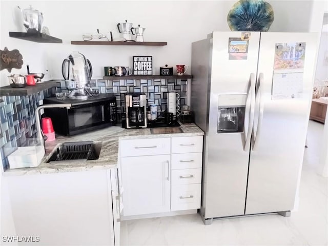 kitchen with white cabinetry, light stone counters, and stainless steel refrigerator with ice dispenser