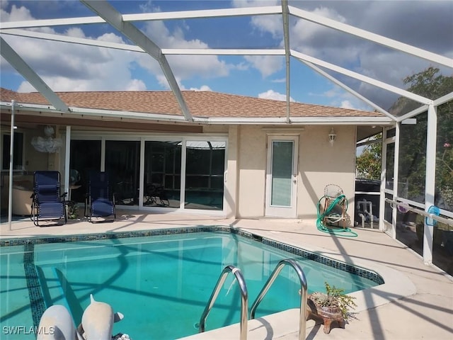 view of pool with a lanai and a patio