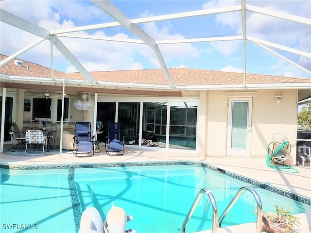 view of pool featuring a patio, a lanai, and ceiling fan