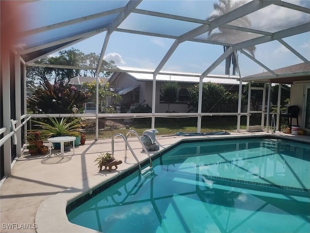 view of pool featuring a patio area and glass enclosure