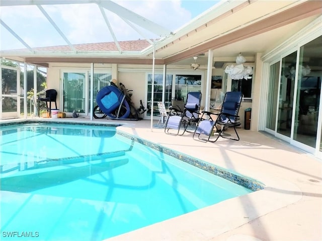 view of swimming pool featuring a patio, a lanai, and ceiling fan