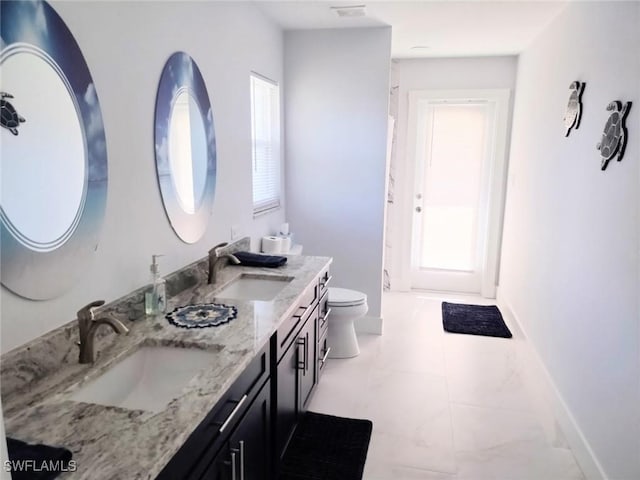 bathroom featuring vanity and toilet