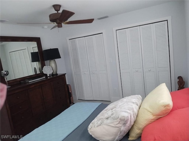 bedroom featuring multiple closets and ceiling fan