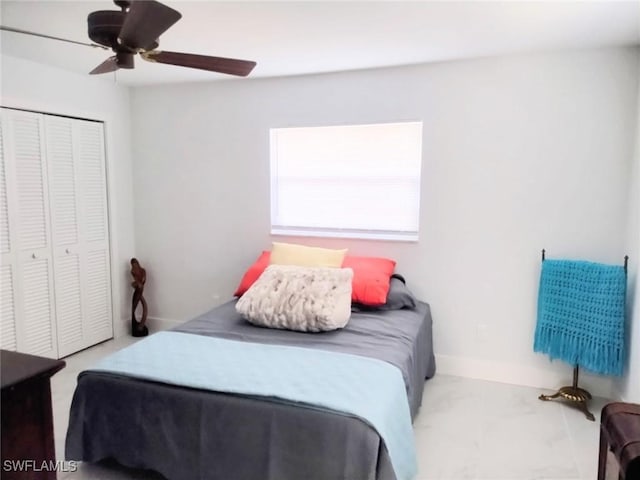 bedroom with ceiling fan and a closet