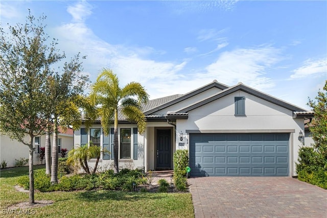 ranch-style house featuring a garage and a front lawn