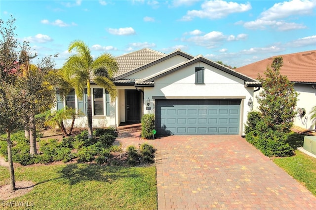 ranch-style house featuring a garage and a front yard