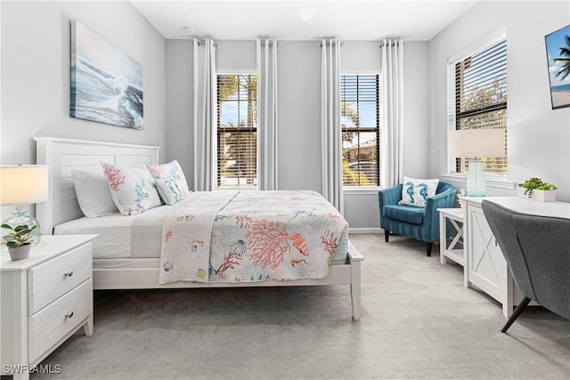 bedroom with light carpet and baseboards