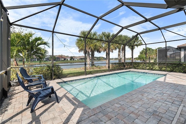 outdoor pool featuring a lanai, a water view, and a patio