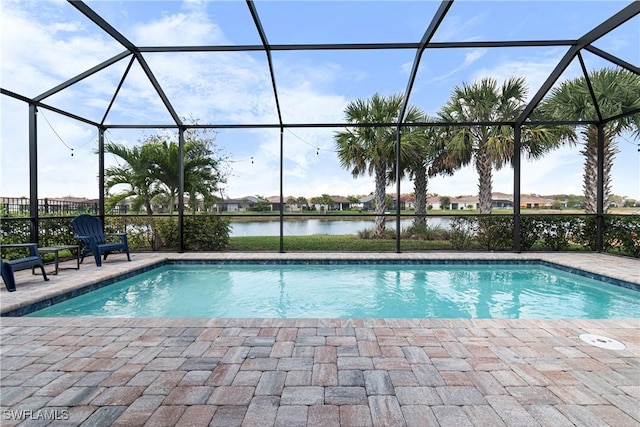 outdoor pool with a lanai, a patio, and a water view