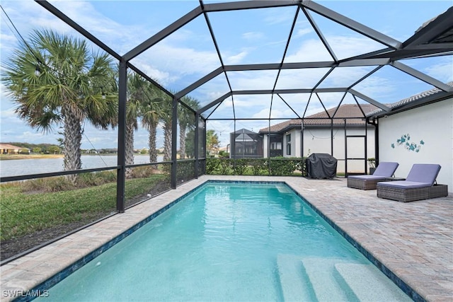 outdoor pool featuring glass enclosure, a water view, a patio, and area for grilling