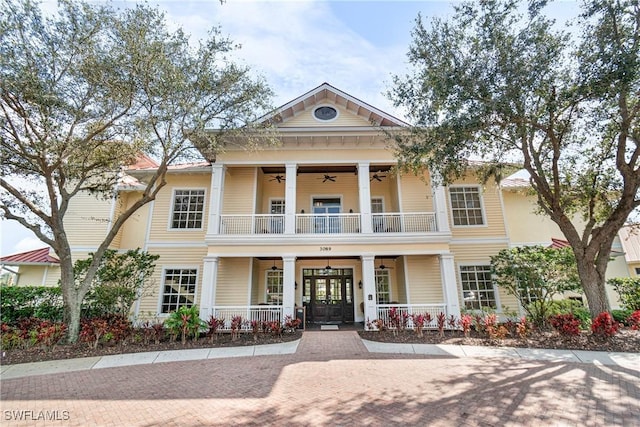 view of front of house with ceiling fan, a porch, a balcony, and french doors