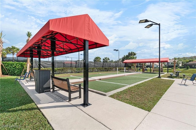 view of home's community featuring fence