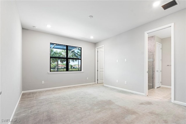 unfurnished bedroom with baseboards, visible vents, recessed lighting, and light colored carpet