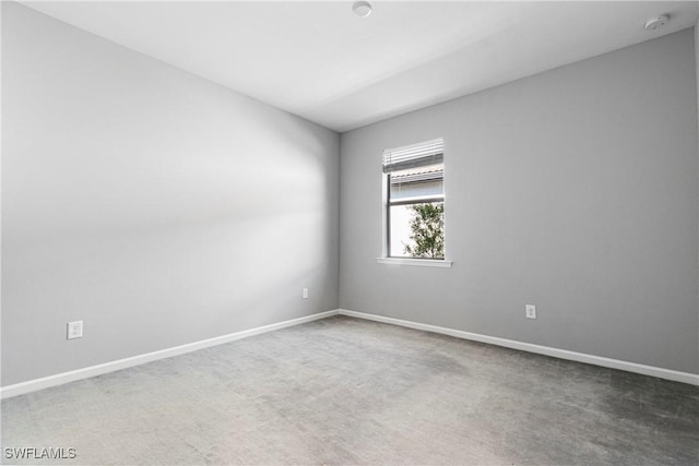 empty room with carpet floors and baseboards