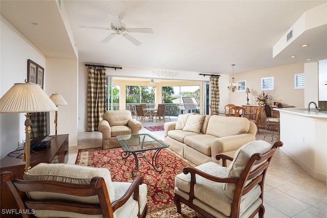 living room with light tile patterned floors, sink, and ceiling fan