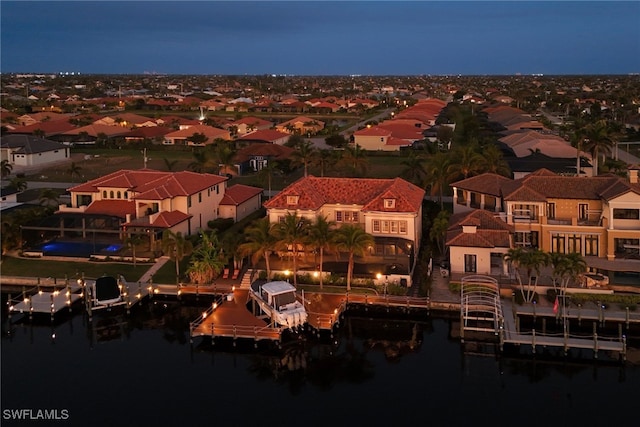 aerial view at night with a residential view and a water view