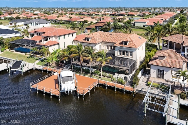 drone / aerial view with a residential view and a water view