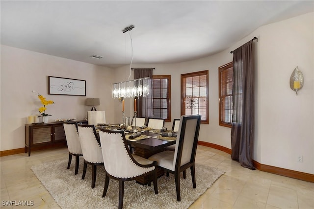 dining area with an inviting chandelier, baseboards, and visible vents