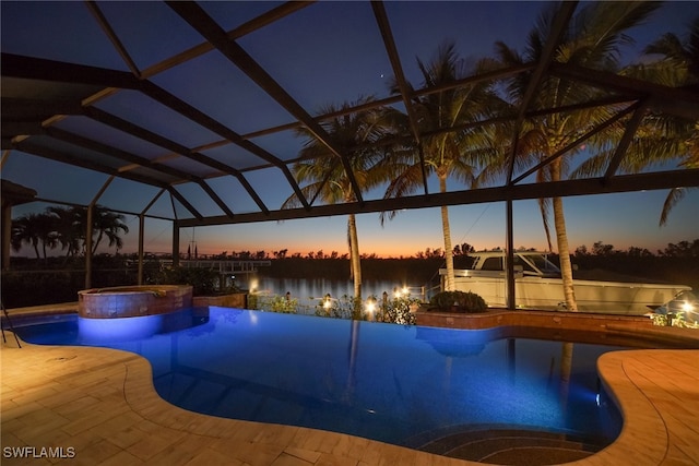 view of pool featuring a lanai, a patio area, and a pool with connected hot tub