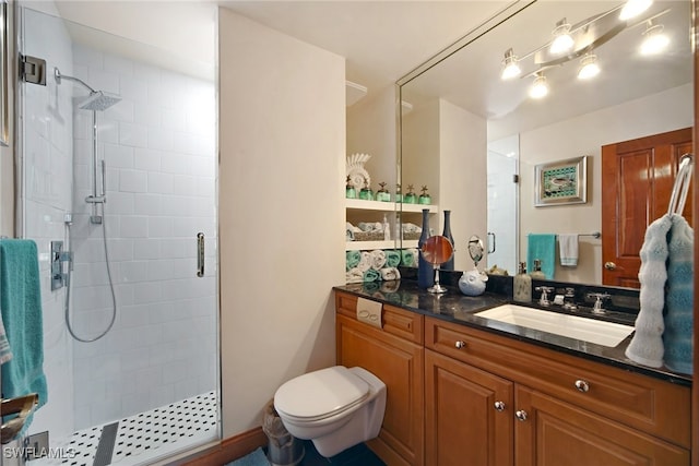 full bath featuring a stall shower, vanity, and toilet