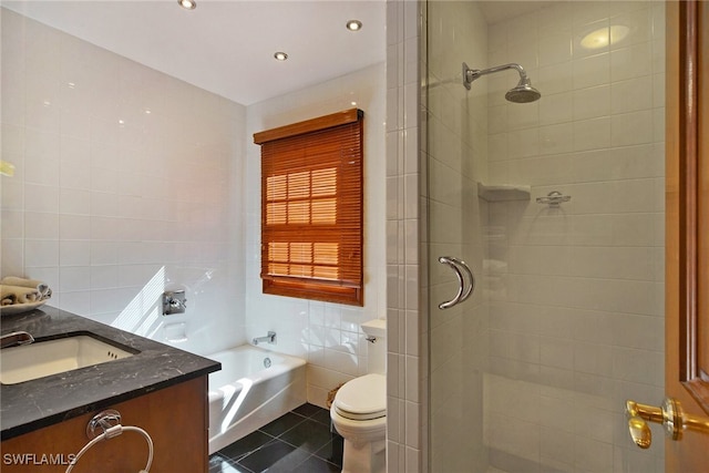 full bathroom with tile walls, toilet, vanity, tile patterned flooring, and a bath