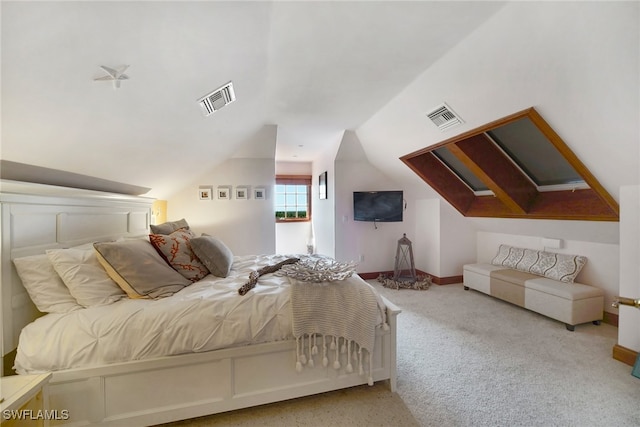 bedroom featuring vaulted ceiling, visible vents, and light colored carpet