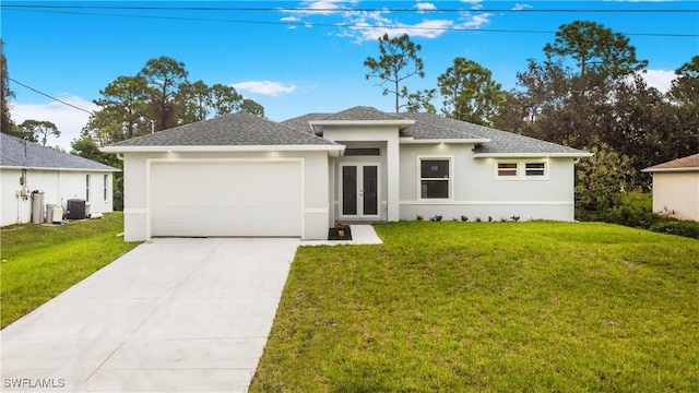 view of front facade featuring a garage, cooling unit, a front yard, and french doors