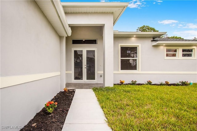 doorway to property with a yard and french doors