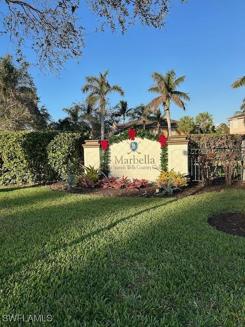 community / neighborhood sign with a lawn