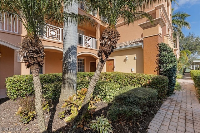 9621 Spanish Moss Way Unit 3813, Bonita Springs, FL 34135 - property entrance with stucco siding and a balcony