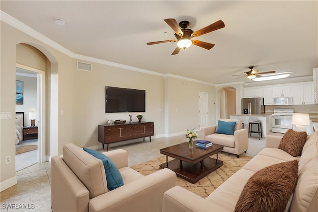 living room with ornamental molding, light tile patterned flooring, and ceiling fan