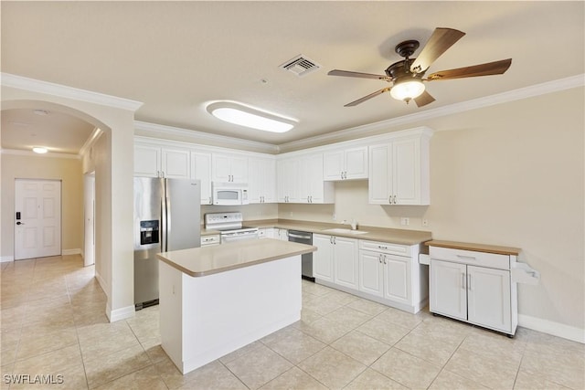 kitchen featuring white cabinetry, crown molding, stainless steel appliances, and a center island