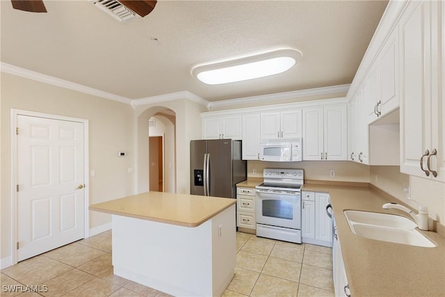 kitchen featuring white cabinetry, sink, a center island, crown molding, and white appliances